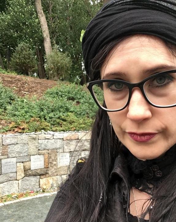 a witch at salem witch memorial we remember plaque not enough