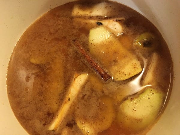 simmer pot with pear skins, cinnamon stick, cardamon pods, nutmeg, clove, and ginger pagan witchcraft holiday diy