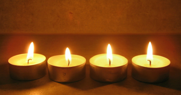 four tea light candles in a row symbolize healing