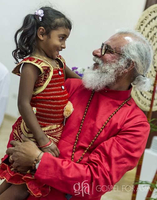 KP Yohannan Holds a Child