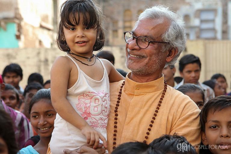 Dr KP Yohannan Metropolitan with a young girl at a Bridge of Hope center in India - KP Yohannan - Gospel for Asia