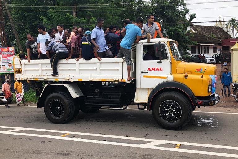 A truck dropping people off at a relief camp in Kerala - KP Yohannan - Gospel for Asia