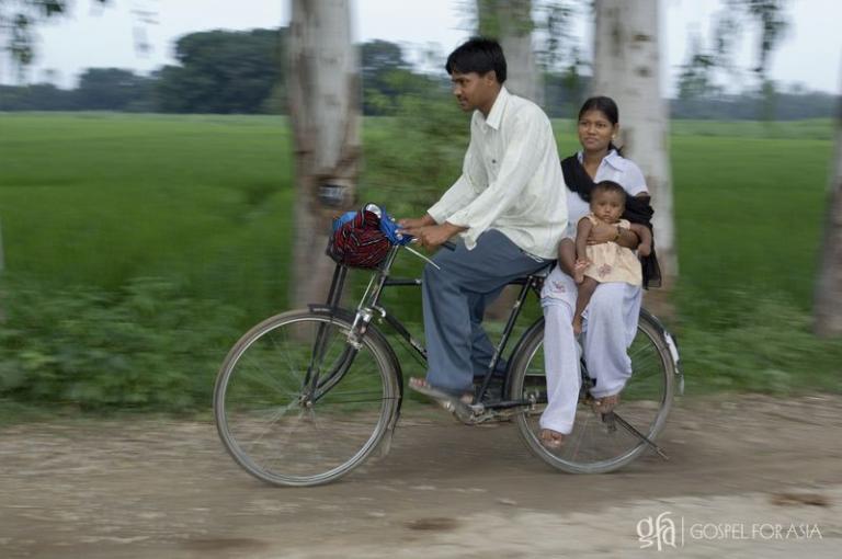 Sandeep on his way to encourage believers with his wife and child - KP Yohannan - Gospel for Asia