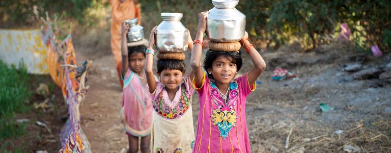 Asian girls carrying water for miles in a global clean water crisis - KP Yohannan - Gospel for Asia