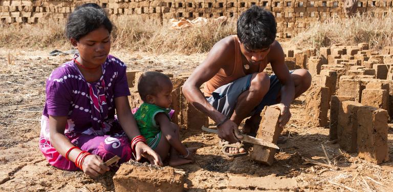 This woman works alongside her husband to make bricks, bringing her infant with her - KP Yohannan - Gospel for Asia