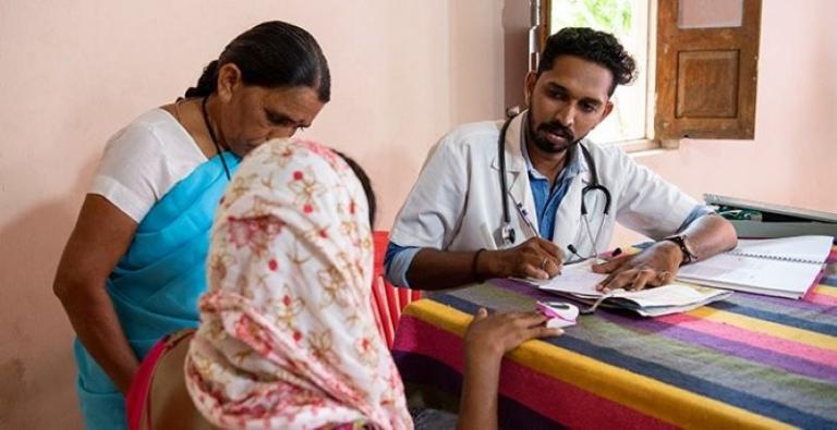 Giving careful, thorough examinations, Dr. Nipun (pictured) prescribes medication donated by a hospital. Dr. Nipun was impacted by the poverty and sickness he saw at the remote medical camp and offered to come free of charge to future GFA-supported medical camps in the area.