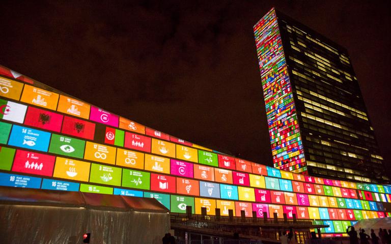 Gospel for Asia shares: The United Nations Building in New York in 2015, displaying the UN’s development goals and the flags of the 193 countries that agreed to them.