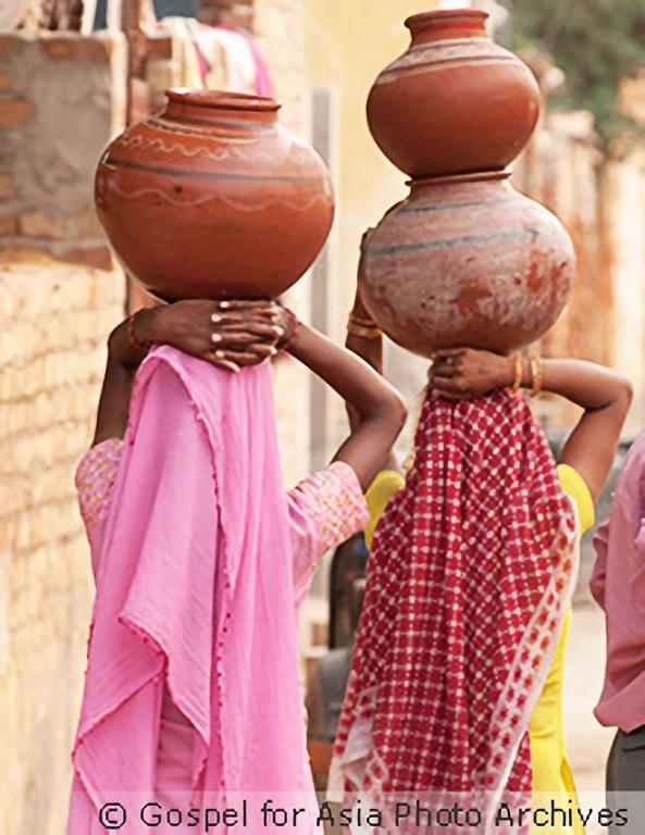 Carrying heavy pots of water is a common sight in many Asian communities—a task made even harder the farther the distance one has to walk.