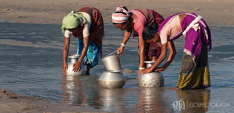 Gospel for Asia founded by Dr. K.P. Yohannan: Women filling buckets with water from ponds.