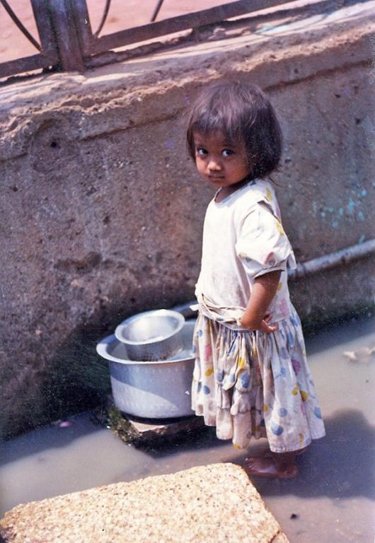 5-year-old Meena, standing in a sewer