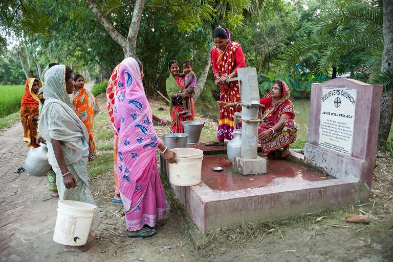 Group of women drawing clean water from Jesus Well.
