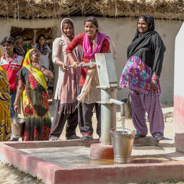 Women drawing clean water from Jesus Well