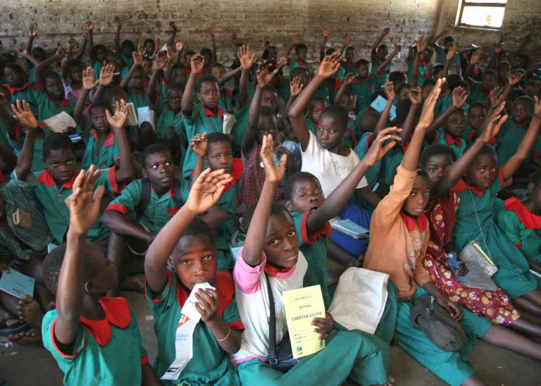 Children participate in a class on malaria and how to protect themselves