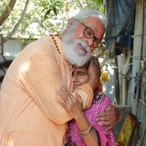 Dr. K.P. Yohannan comforting widow