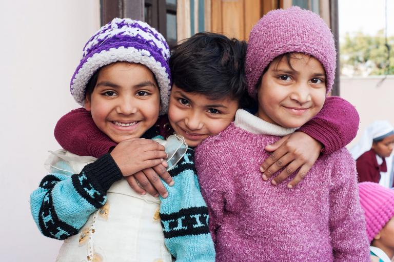 Ashmita, a girl rescued from trafficking, can now smile in safety with friends.