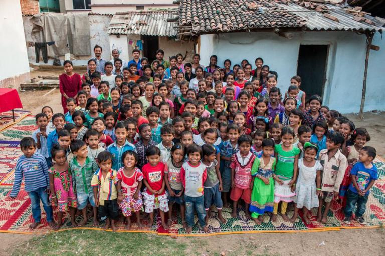 Children in Bridge of Hope center posing together with teachers