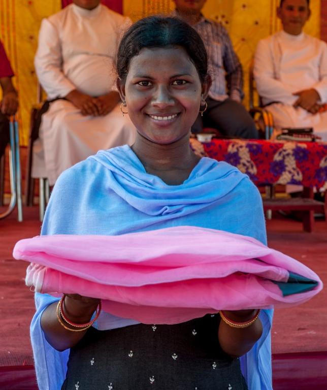 Woman receives mosquito net.