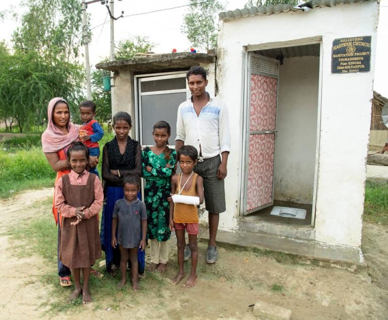 Family standing outside of Outdoor Toilets