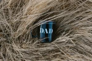 Dad Mug sitting on top of hay