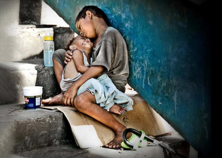 Street children resting outdoors exposed to danger and hunger