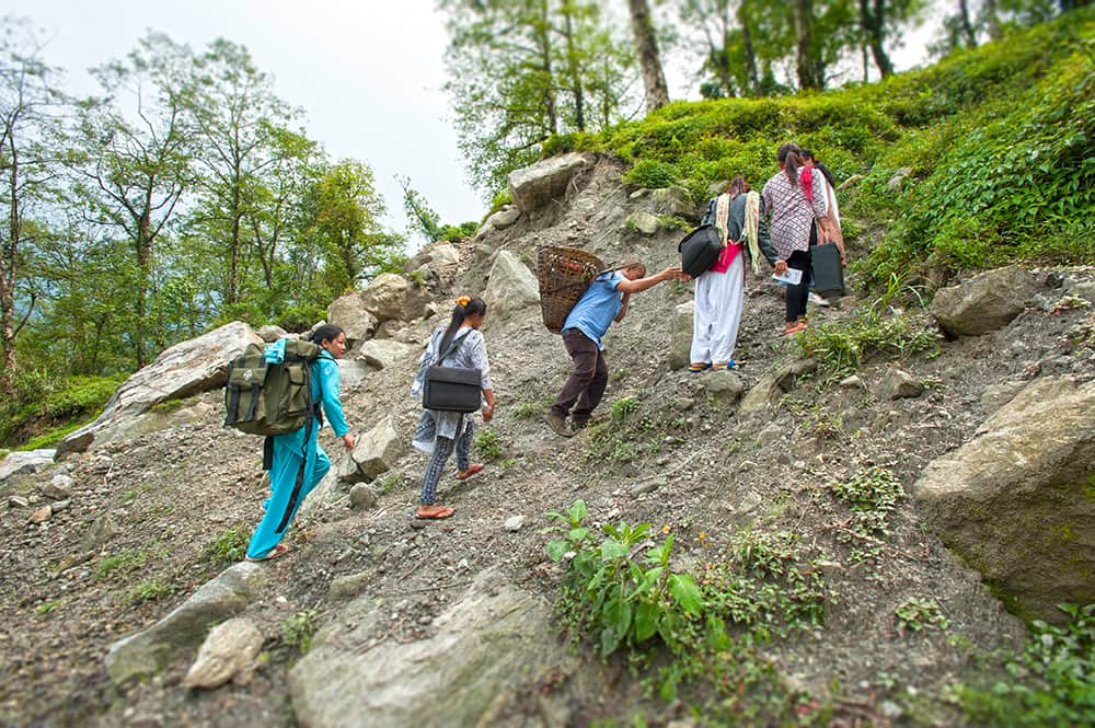 GFA World national missionaries traversing mountainous terrains to deliver supplies and provisions to villages in need.