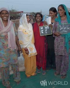 Discussing Gaetane's longing to read & write, the fulfillment through women literacy class led by GFA World Sisters of Compassion workers.