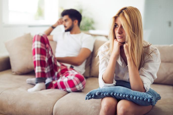 Unhappy young couple having crisis and difficulties in relationship