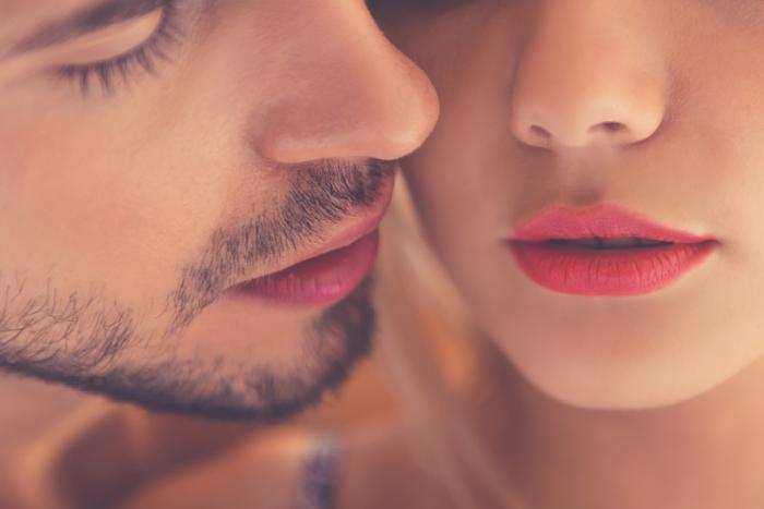 Close-up of beautiful passionate couple kissing while having sex