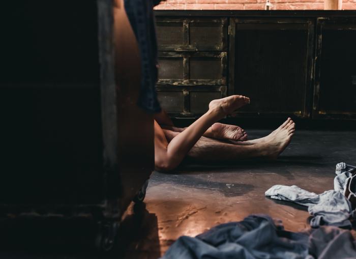 Attractive passionate couple is having sex on kitchen.