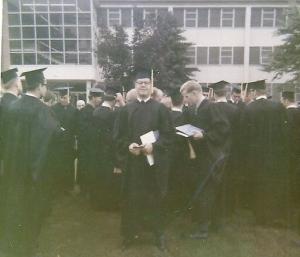 Man in cap and gown at graduation