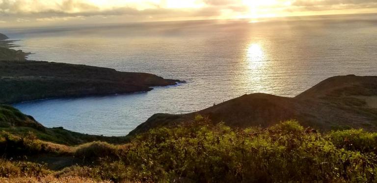 sunrise over bay, mountain, and ocean