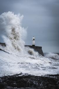 Here is hope lighthouse standing against waves
