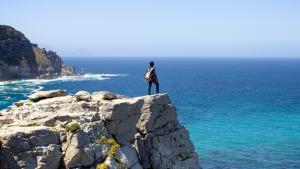 Man standing on the edge of a cliff Am I good enough