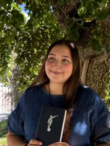 Valeska holding a Book of Mormon as she's serving Jesus Christ