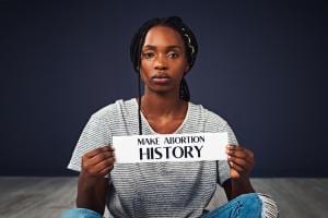 Woman with Make Abortion History Sign