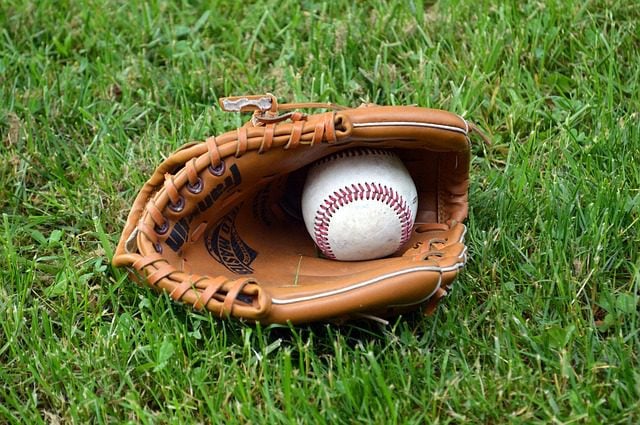 Baseball glove and ball on grass