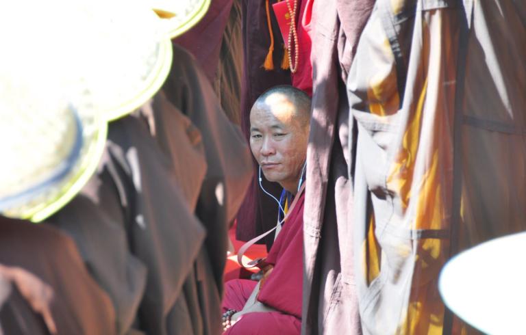 Tibetan monk in China with earphones (photo by author 2016)