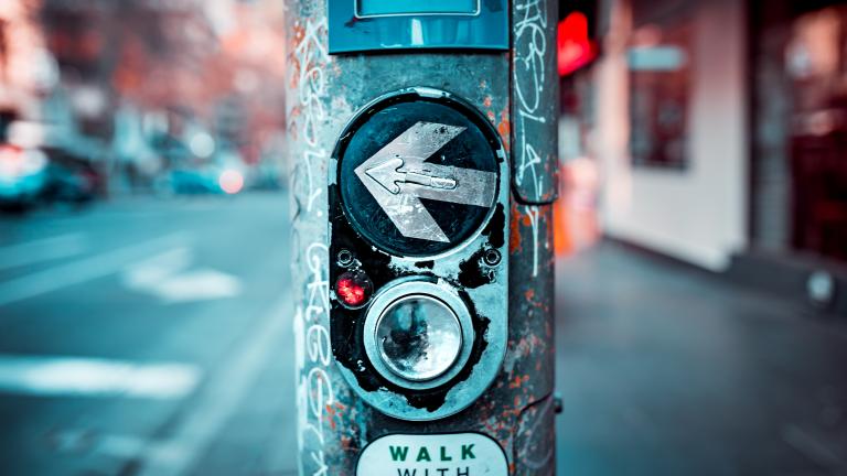 a streetlight button, with an arrow pointed left