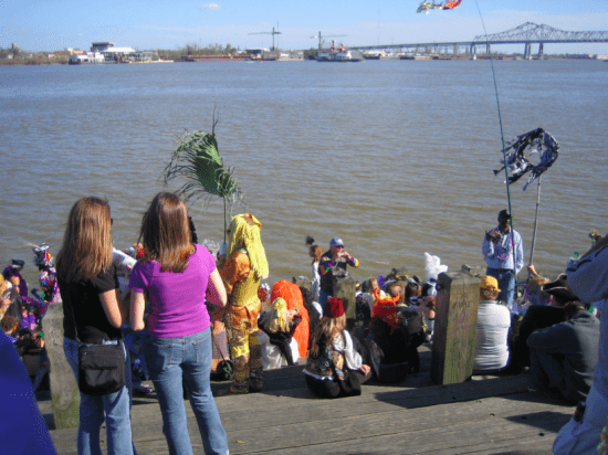 Krewe of St. Anne casting cremains (ashes) into the Mississippi River on Mardi Gras (photo by MME)