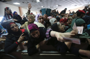 Women show their passports at the Egypt-Gaza border crossing at Rafah, which opened last Sunday for the first time in two months. Image by Ibraheem Abu Mustafa/Reuters