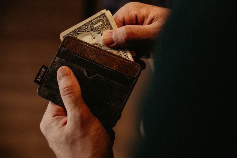 man pulling money out of wallet