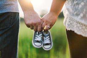 Parents with baby shoes