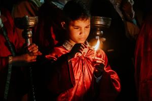 Boy holding candle