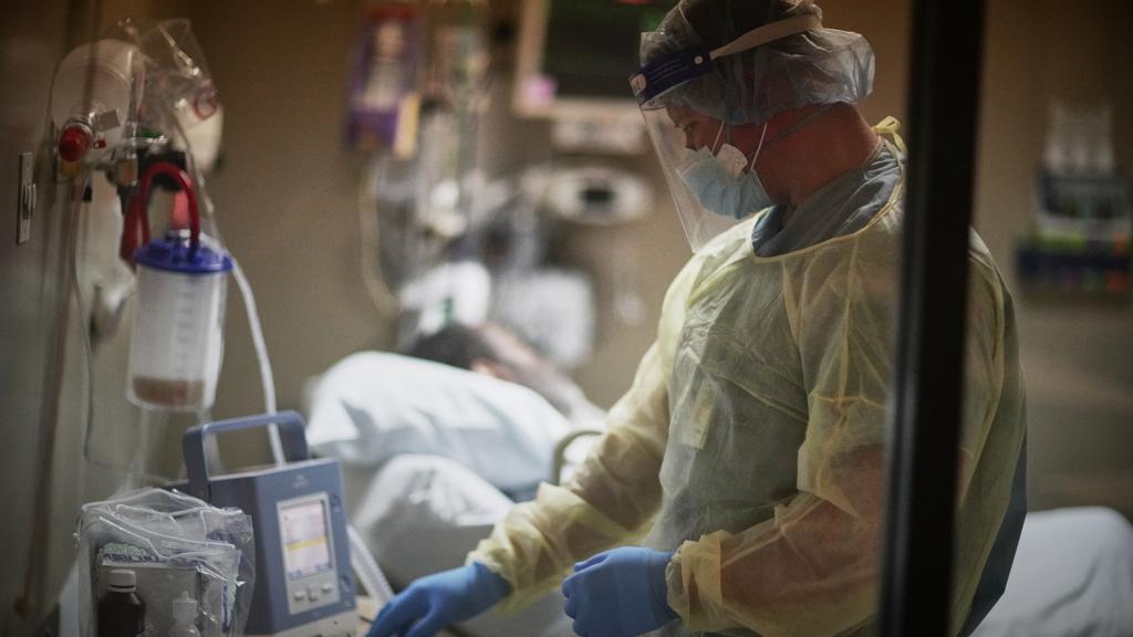 Lt. Cmdr. Michael Heimes checks on a patient connected to a ventilator at Baton Rouge General Mid City campus