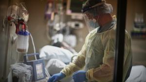 Lt. Cmdr. Michael Heimes checks on a patient connected to a ventilator at Baton Rouge General Mid City campus 