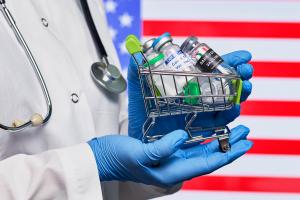 Various vaccines in front of an American Flag