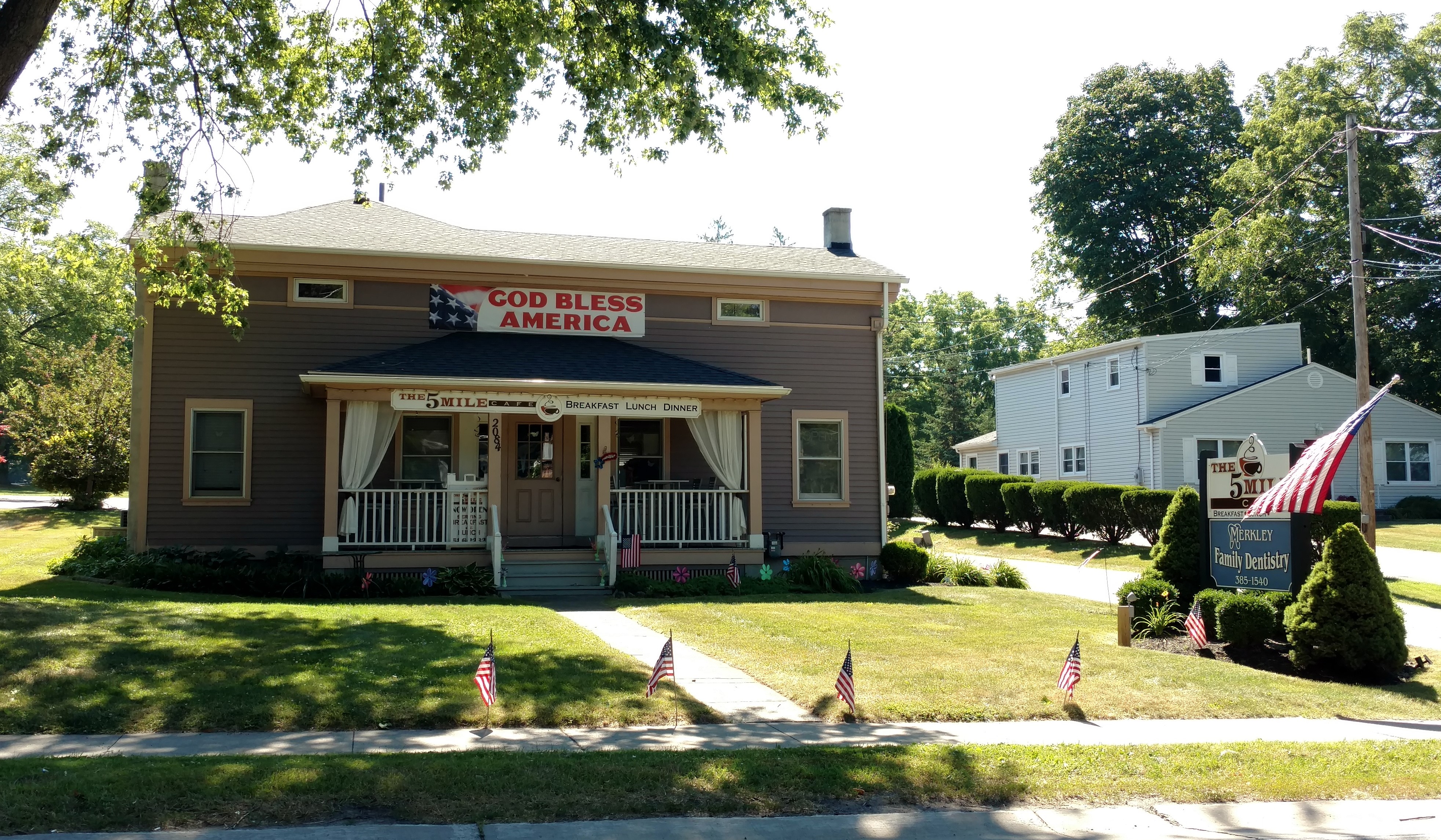 Five Mile Cafe in Penfield, NY, displaying flags and banner