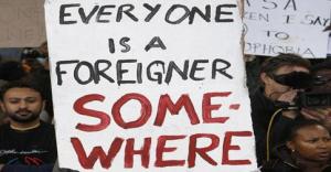 Opposition to xenophobia is expressed by a sign: "Everyone is a foreigner somewhere."