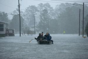 A rescue boat plods through the streets of New Bern, N.C.