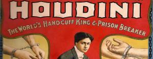 A billboard with Harry Houdini, "handcuff king and prison breaker."